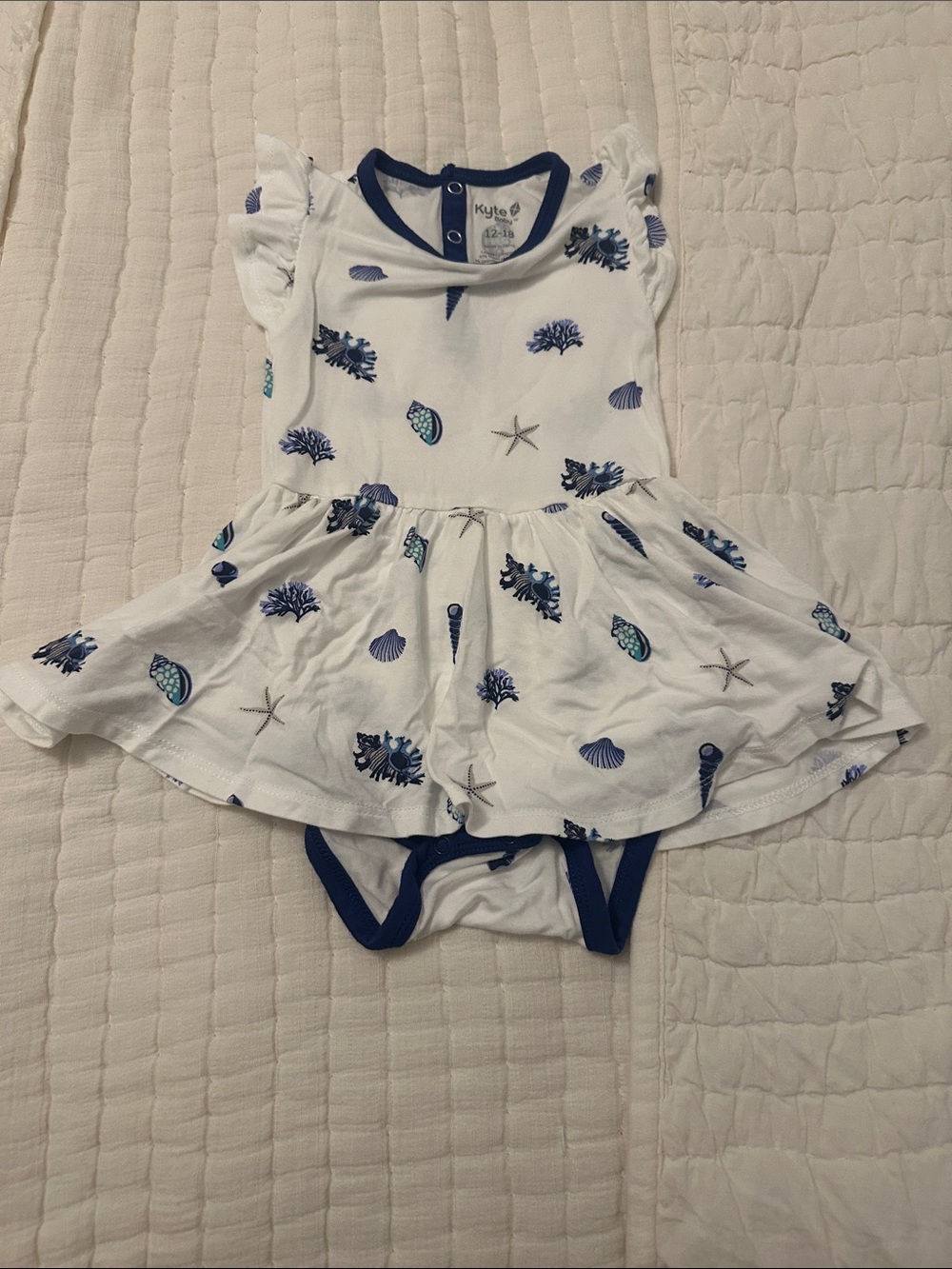 Kyte BABY White Dress Onesie with Navy & Blue Sea Print
